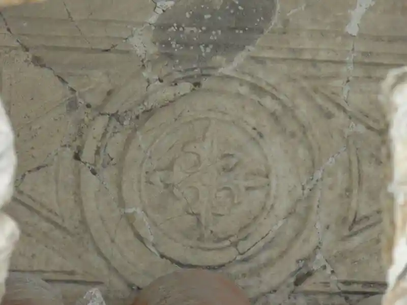 Fleur-de-lis solar cross on what appears to be marble stone in the ruins in Ephesus, Izmir